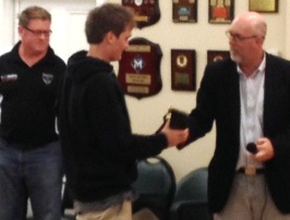 Mitchell Evans receives his Junior Club Champion award from junior co-ordinator Kevin Gardiner, watched by Under 16 coach Simon Thornton. 